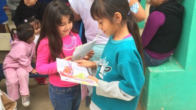 Baja migrant children enjoy books brought by the Flying Samaritans